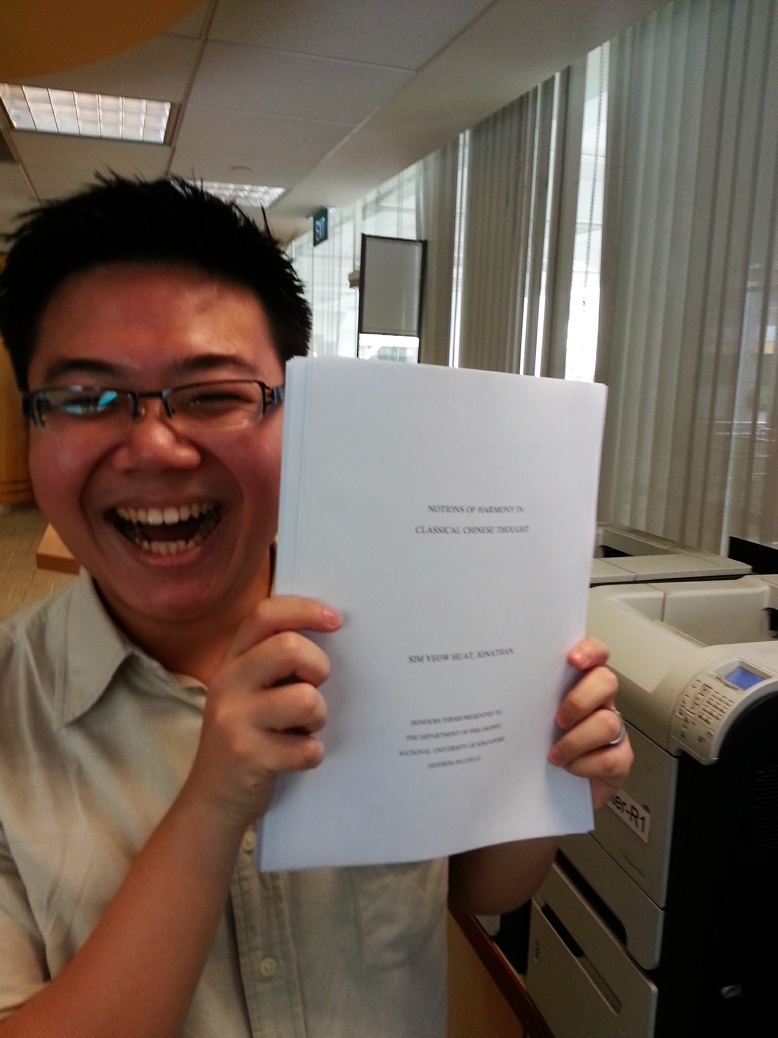 Proudly displaying the printed thesis! Notice the disheveled hair from the many overnight editing/writing marathons.